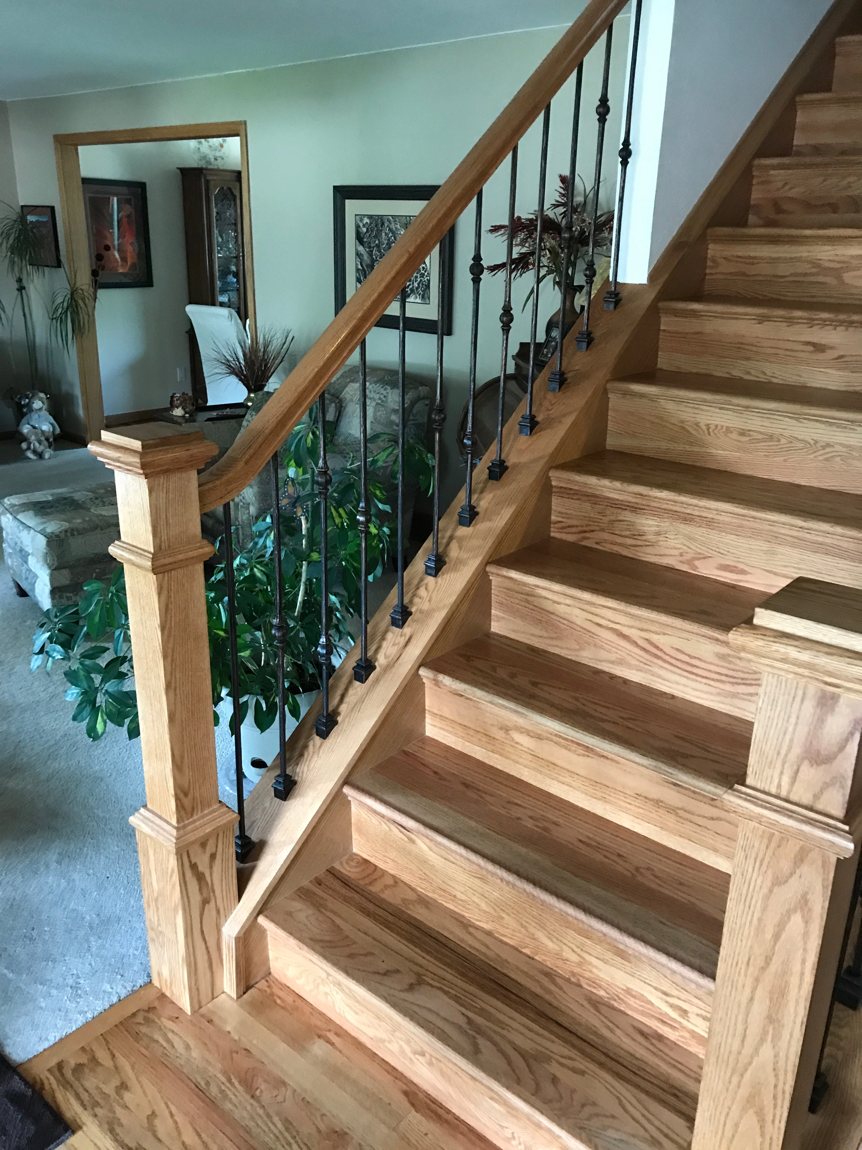 Box newel post installed with stained handrail on Denver stair remodel