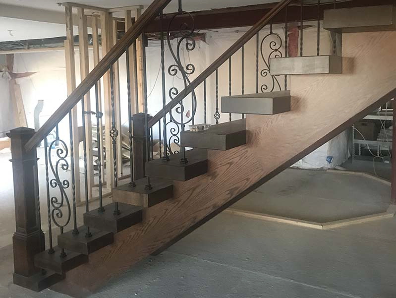 Stained oak handrail installed on remodeled Denver staircase