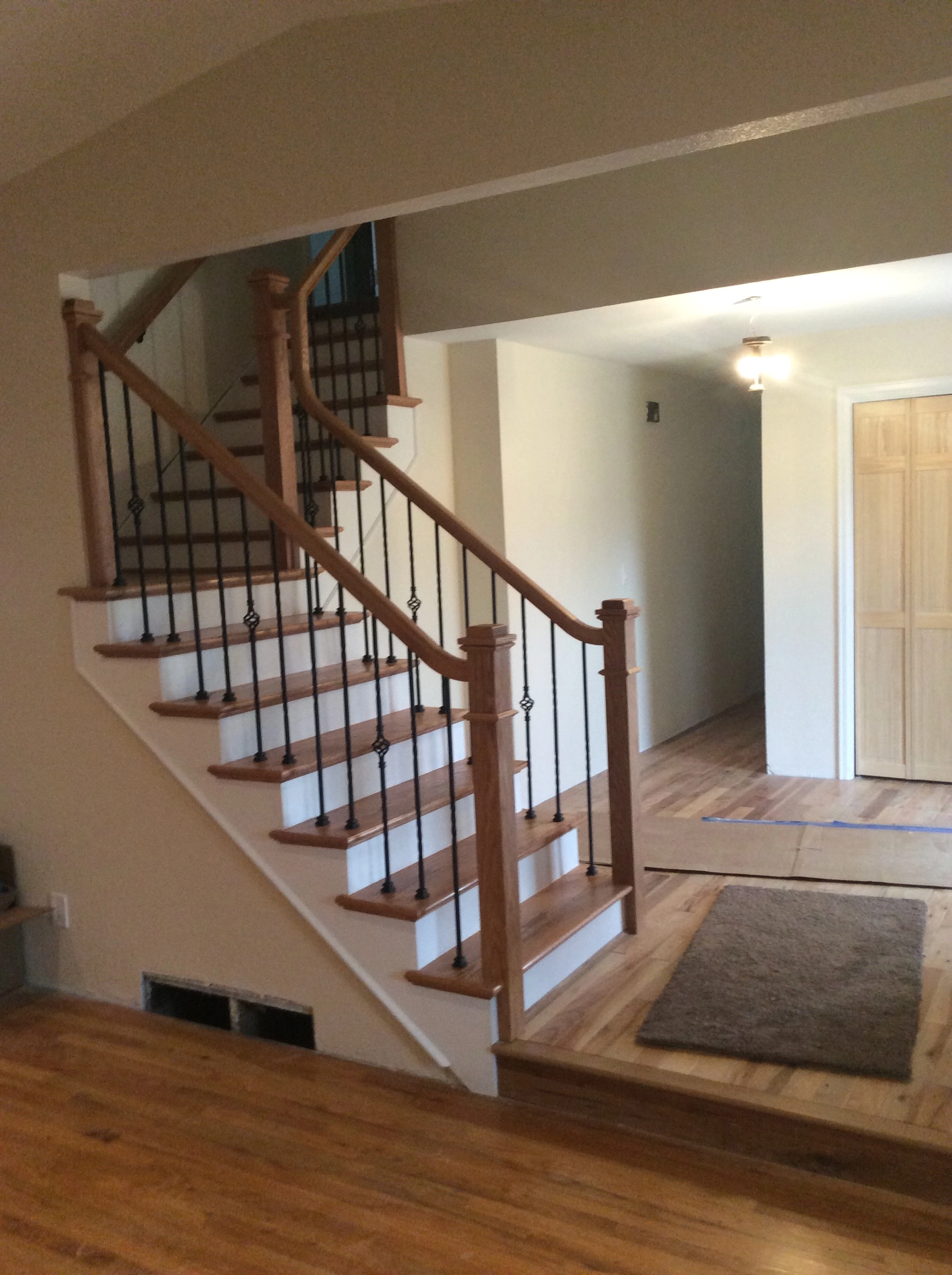 Painted stair risers with stained oak treads and finished skirt boards