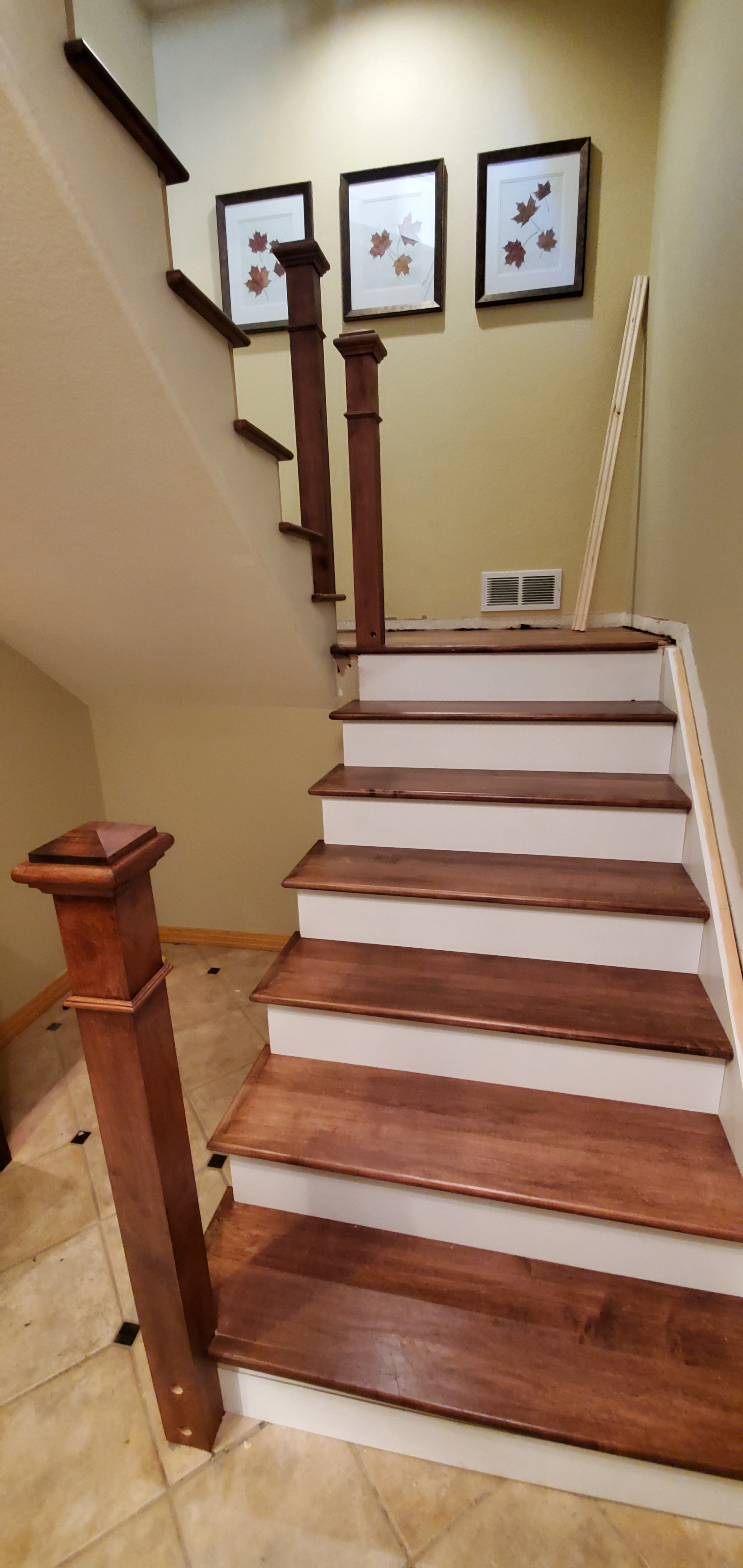 Oak stair tread replacement with painted white risers in a Denver home