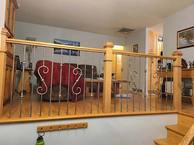 Iron gothic baluster upgrade with wood handrail on Denver stair remodel