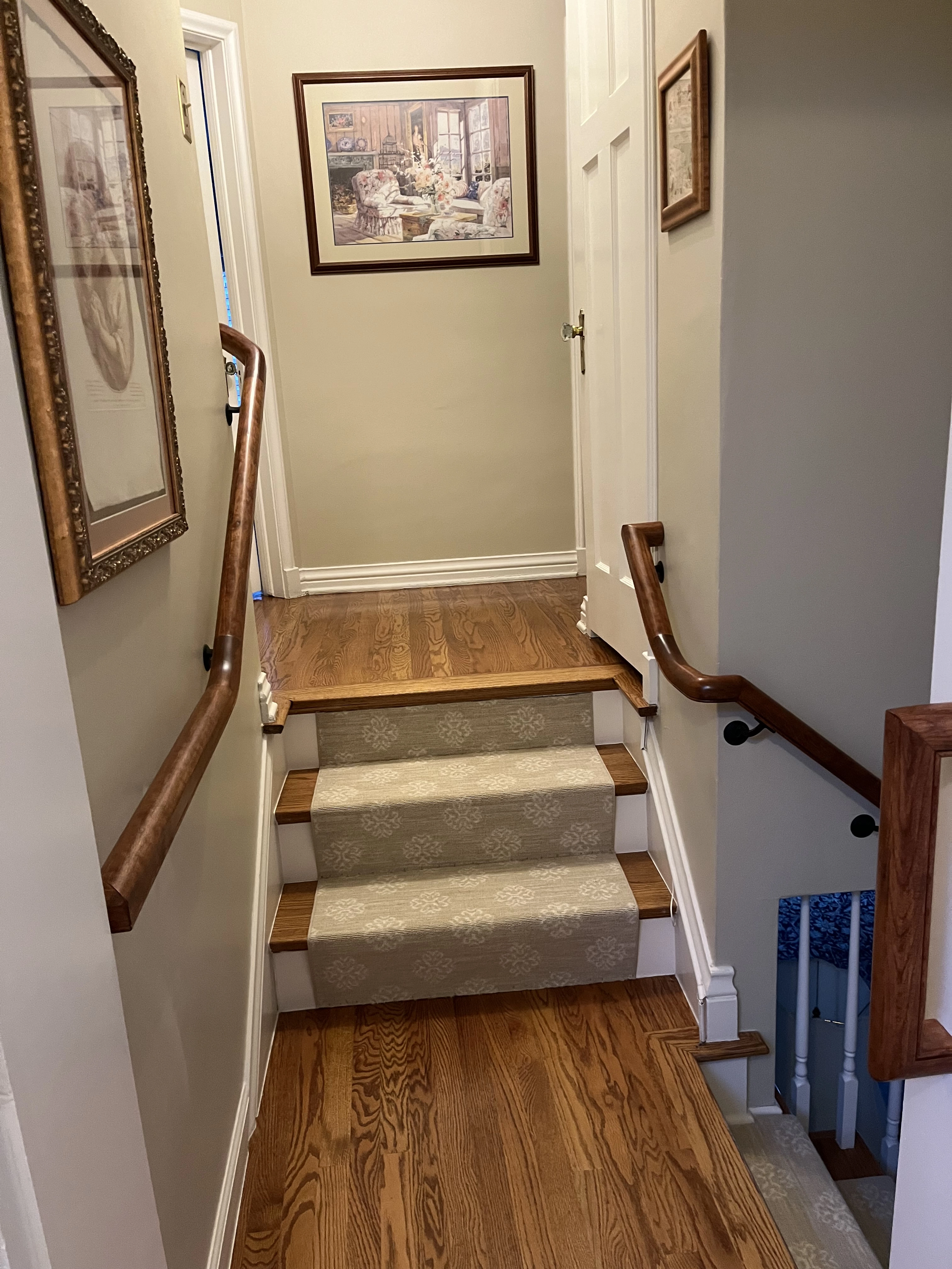 Wood wall rail installed along interior staircase in Denver home